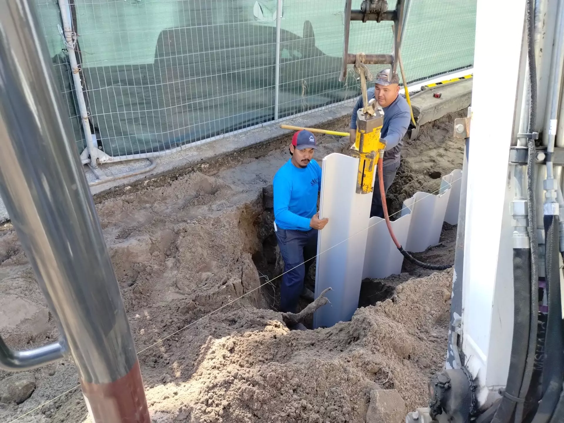 A pneumatic shoring hammer is used to drive the panel into the ground