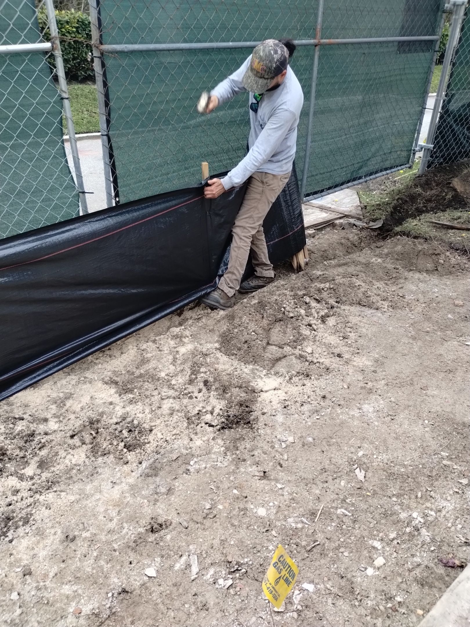 The trench method requires a trench to be dug, and the bottom 6 inches of mesh to be folde inwards, then backfilled.