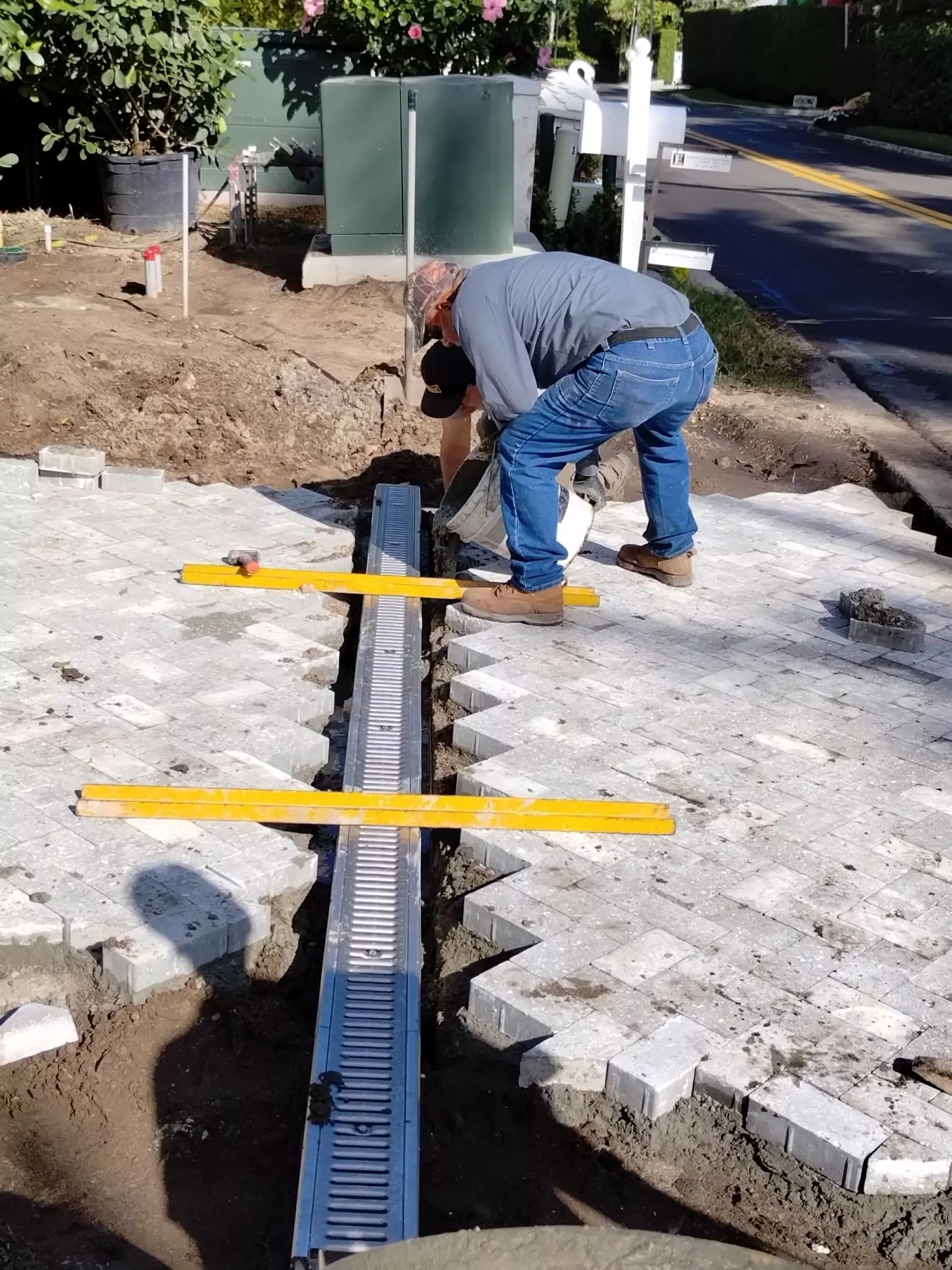 The drain is put in place above the stub ups, and the concrete is backfilled underneath the drain